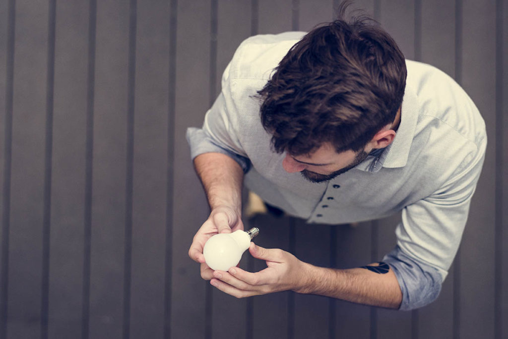 A man changing a light bulb