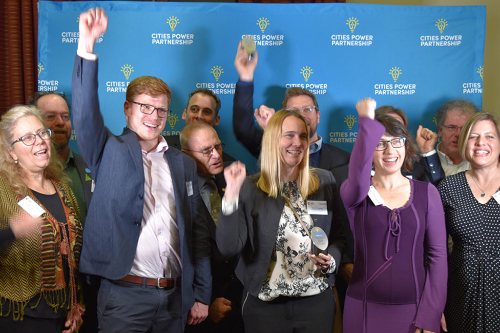 A photo of the CPP award winners punching the air and celebrating.