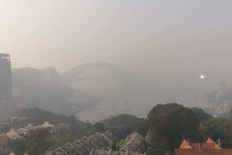 A photo of Sydney Harbour Bridge with smoke haze