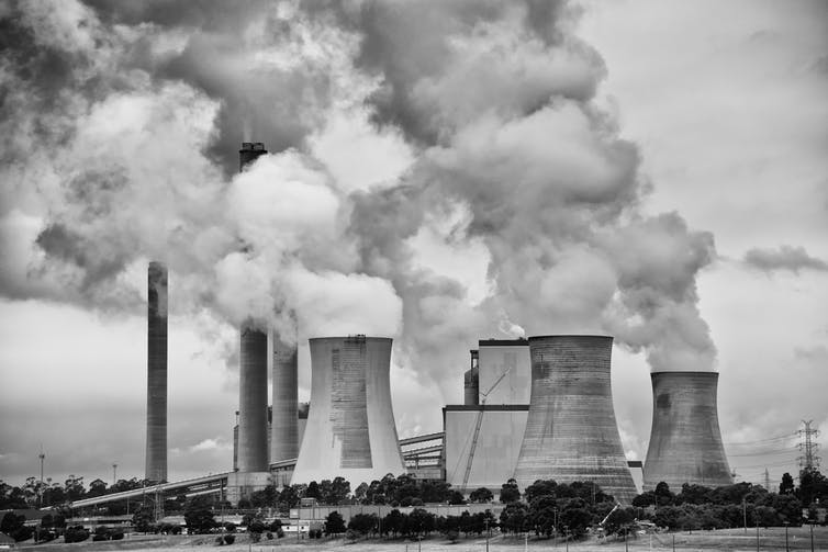 Smoke stacks billowing from a power plant