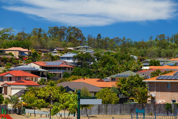 A series of rooftops with solar panels attached