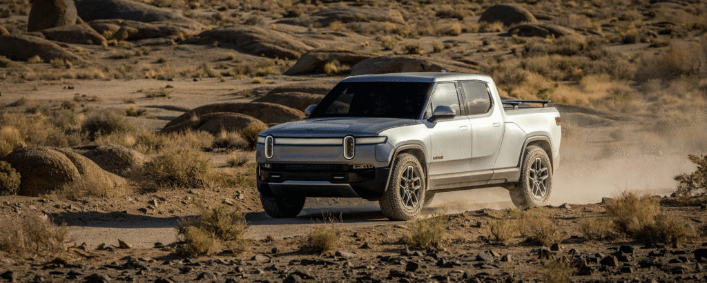 Electric Ute parked in front of wind turbines