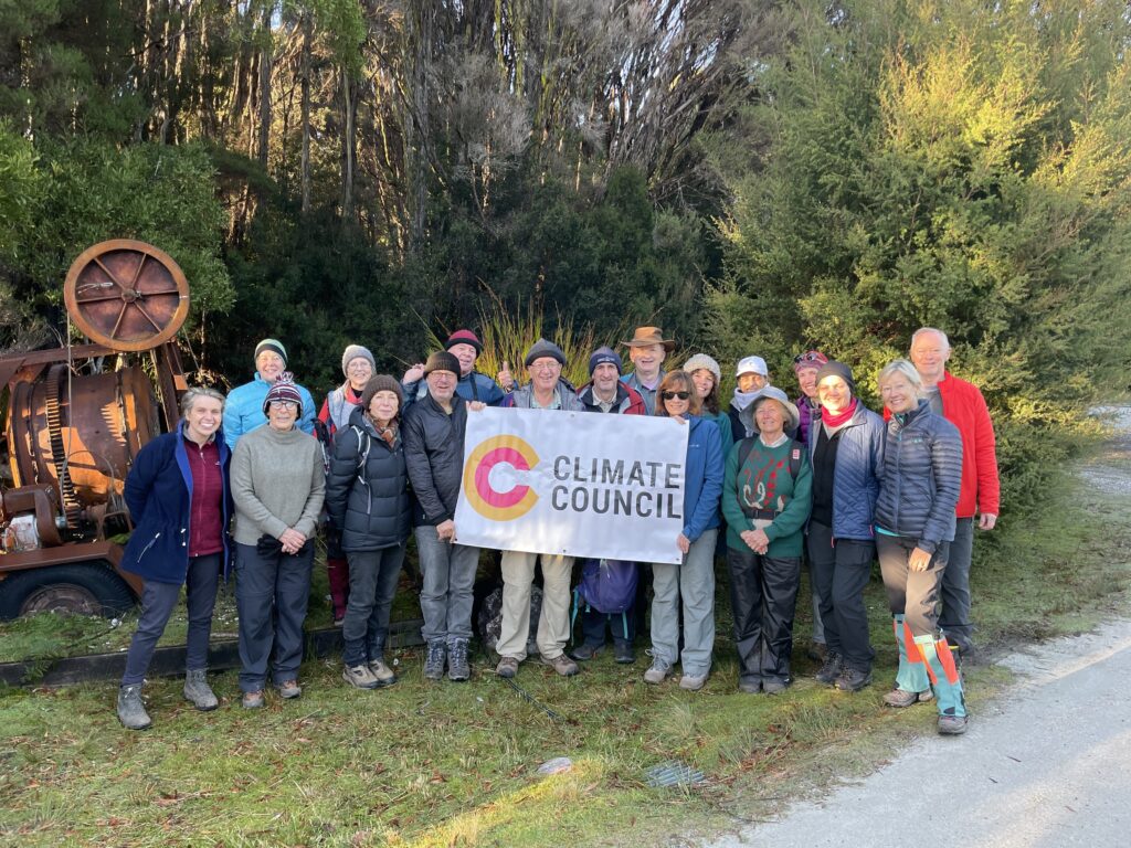 Group of people standing and holding a Climate Council banner